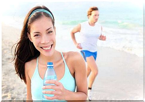 Woman smiling and drinking water