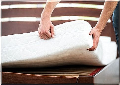 Man turning mattress