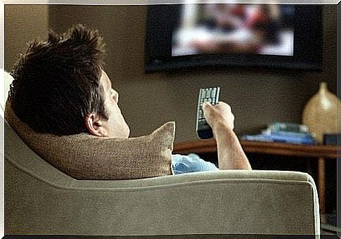 Man sitting on the couch in front of the TV