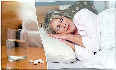 Woman with sleeping pills on bedside table