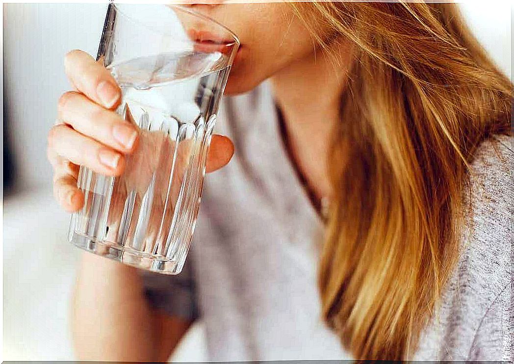 A woman drinking a glass of water