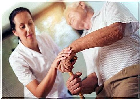 Elderly man is assisted by caregiver