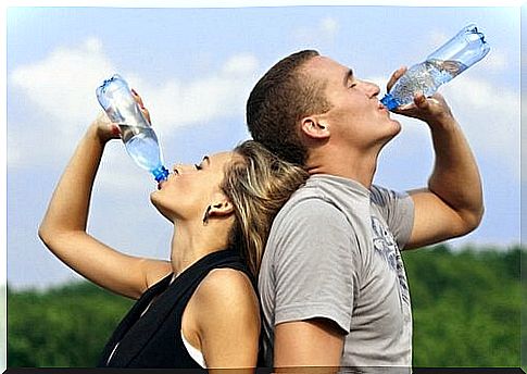 Couple drinking from bottle