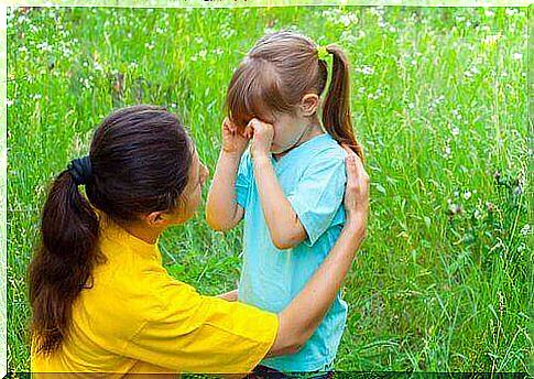 A mother who comforts her daughter.