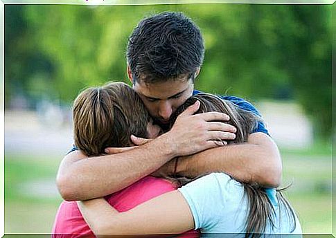 husband hugs children