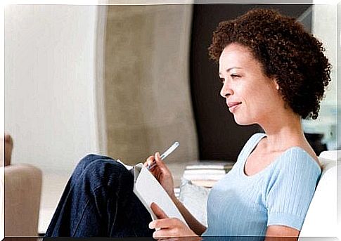 Woman writing in book