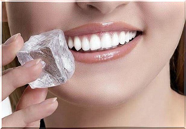 Woman holding an ice cube up to her mouth - whole blister