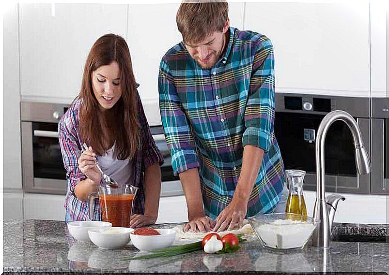 A couple making homemade pizza