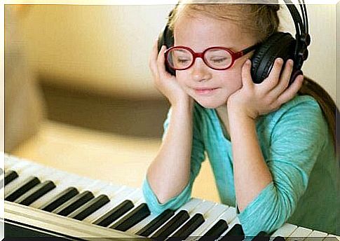 Girl listening to music at piano illustrates intellectual disability