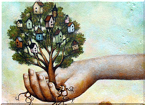 hand holding a tree with houses