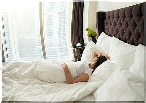 Woman lying in comfortable bed