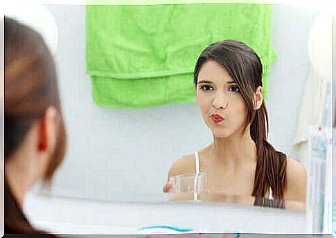 Woman uses mouthwash