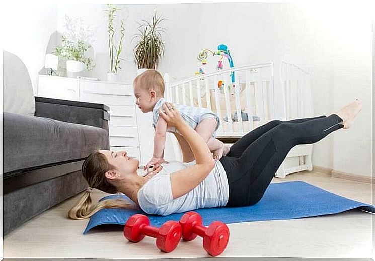 Mother playing with her baby - mother as a 35-year-old