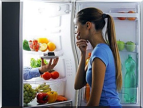 Woman looking tempted into the fridge