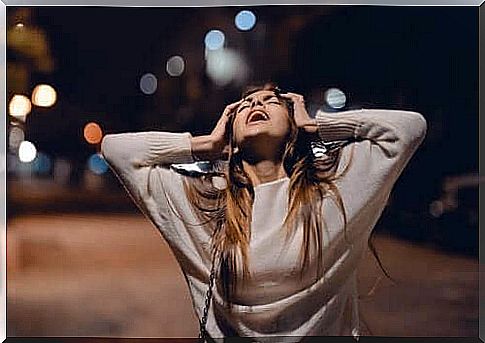 Woman on the road in the evening shows anger