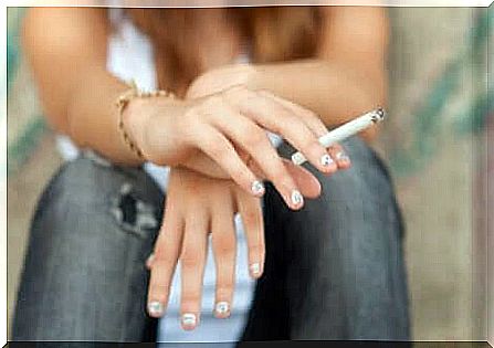 A teenager smokes