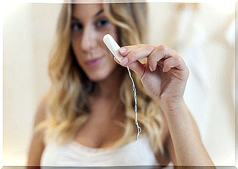 Woman showing a tampon